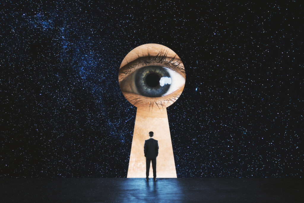 keyhole with eye and man standing infront of it