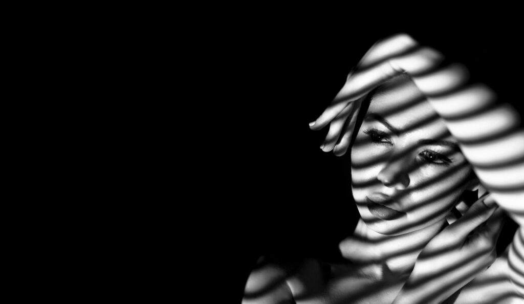 black and white portrait of a woman with striped shadows