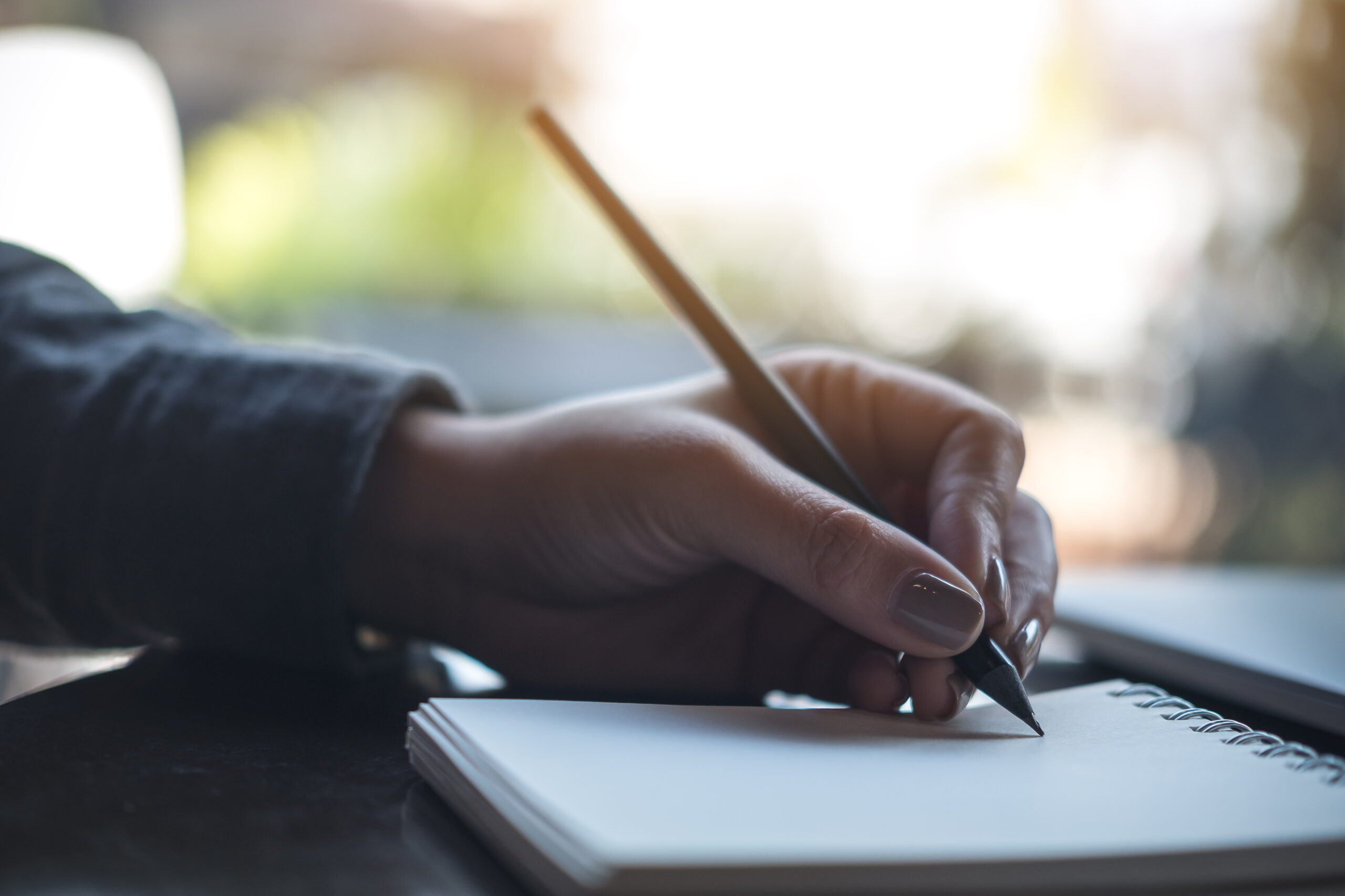 storytelling and writing in a notebook with womans hands