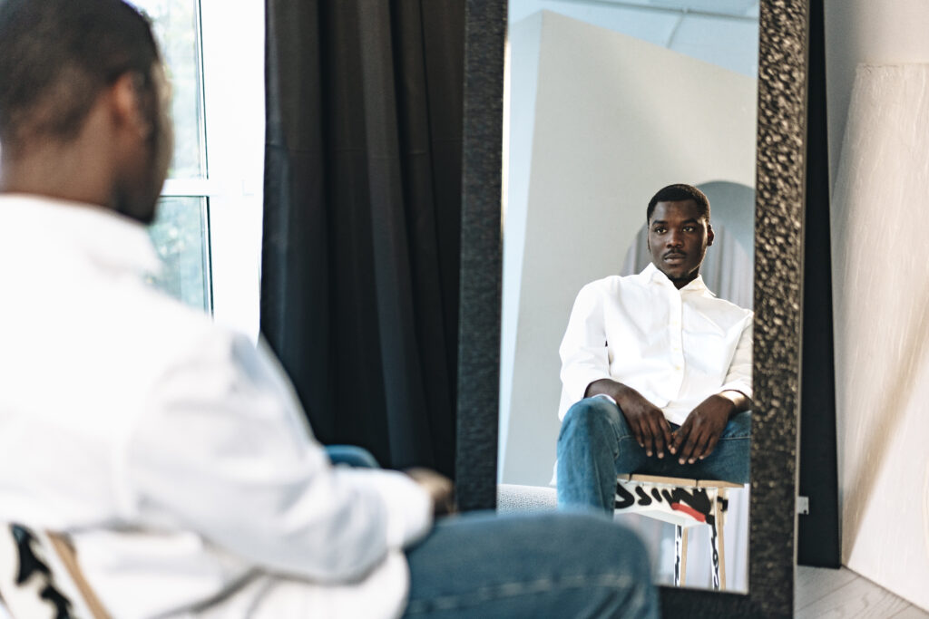 man looking at himself in the mirror