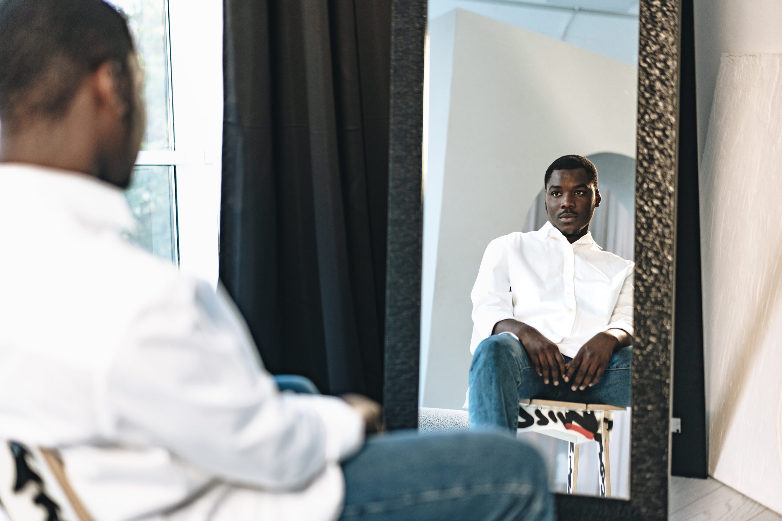 man looking at himself in the mirror