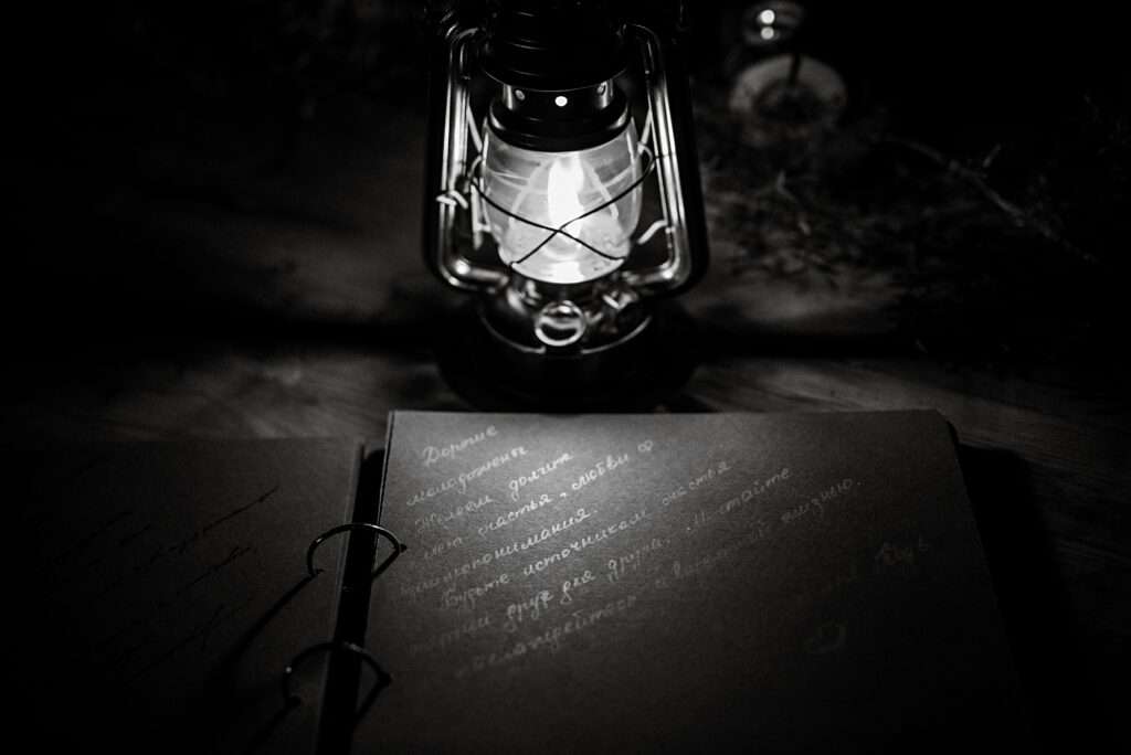 lantern and writing in the dark, pages are illuminated